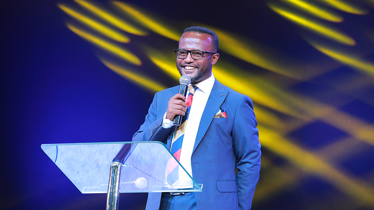 Pastor Yonathan Aklilu addressing youth at the conference